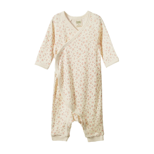 A baby long-sleeve footless sleep sack in cream with a tiny pink and green floral print, shown against a plain white background.