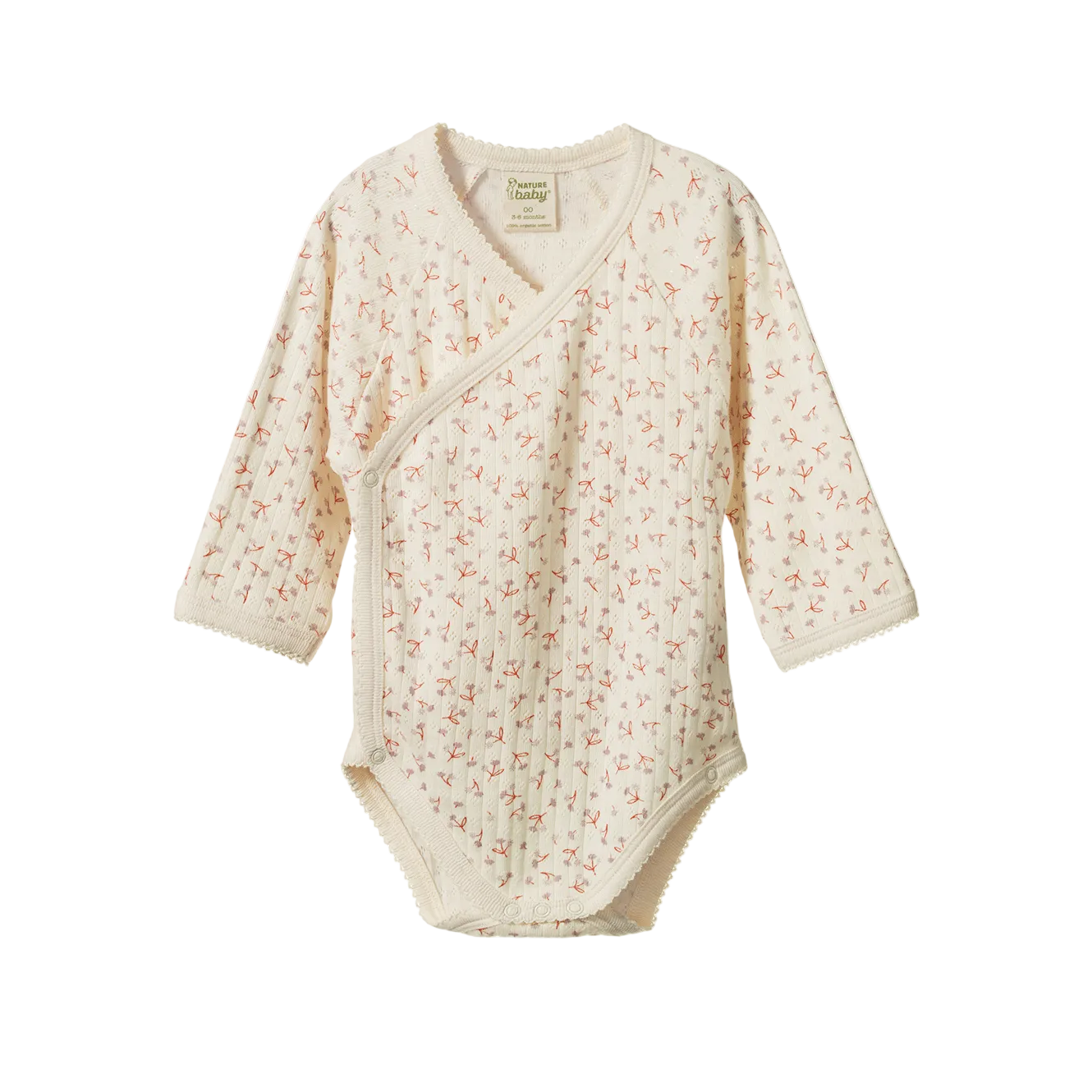A long-sleeve baby wrap bodysuit in cream-colored cotton muslin with a delicate pink and green floral print, shown flat on a white background. 