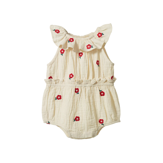 A cream-colored cotton gauze baby romper with red floral embroidery, featuring ruffled shoulder straps and a ruffled waist, shown against a plain white background.