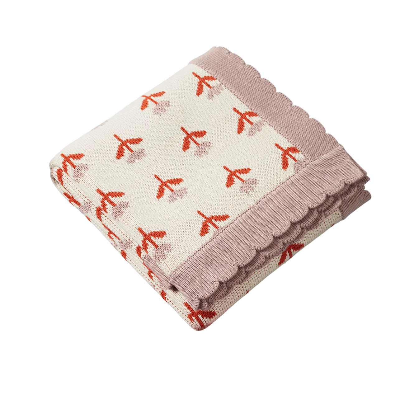 A folded knit blanket with a scalloped edge, featuring a cream background with a pattern of small red and dusty pink flowers, and a solid dusty pink border.